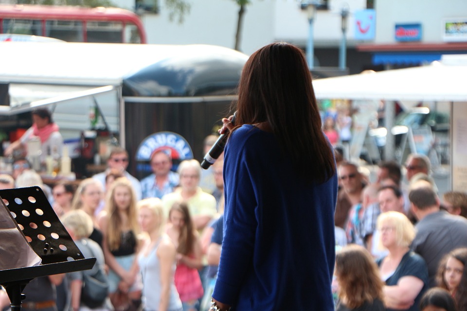 A woman on stage at a festival.