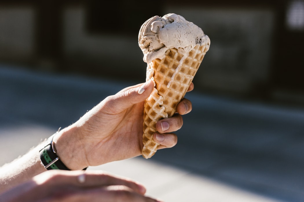 A man holding an ice cream cone.