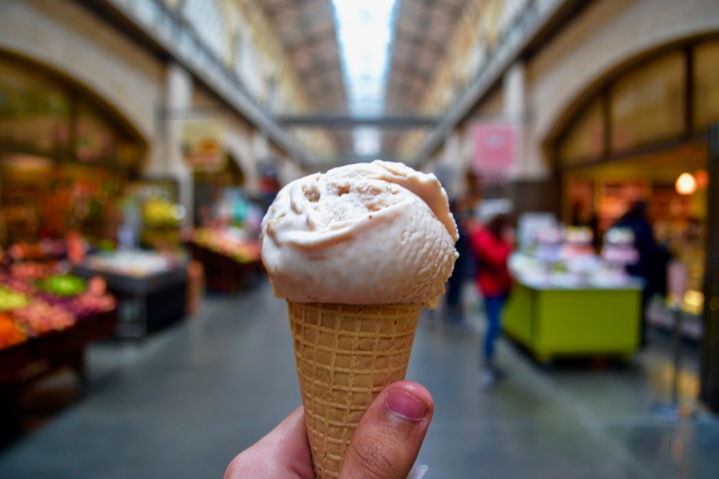 A person holding up an ice cream.