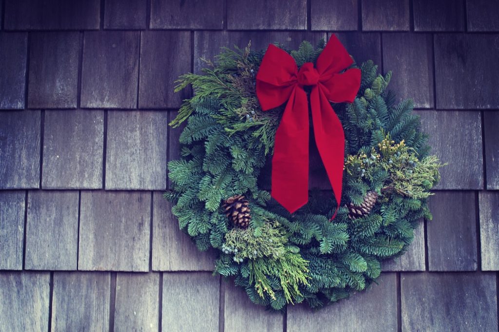 A holiday wreath hanging up as part of staging your home during the holiday season. 